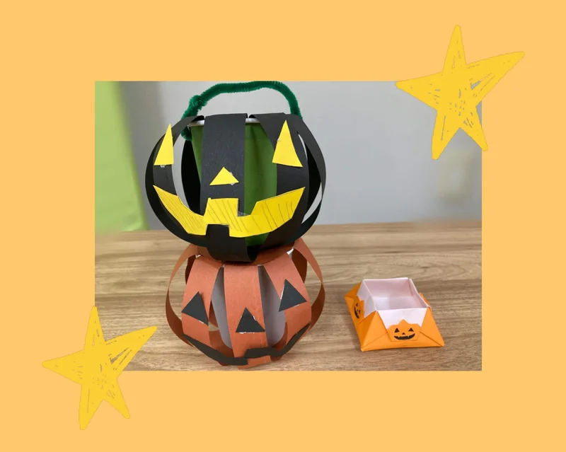 真田山教室 ハロウィンの作品 — 黒とオレンジのかぼちゃのバッグと、ジャック・オー・ランタンの顔の折り紙の箱